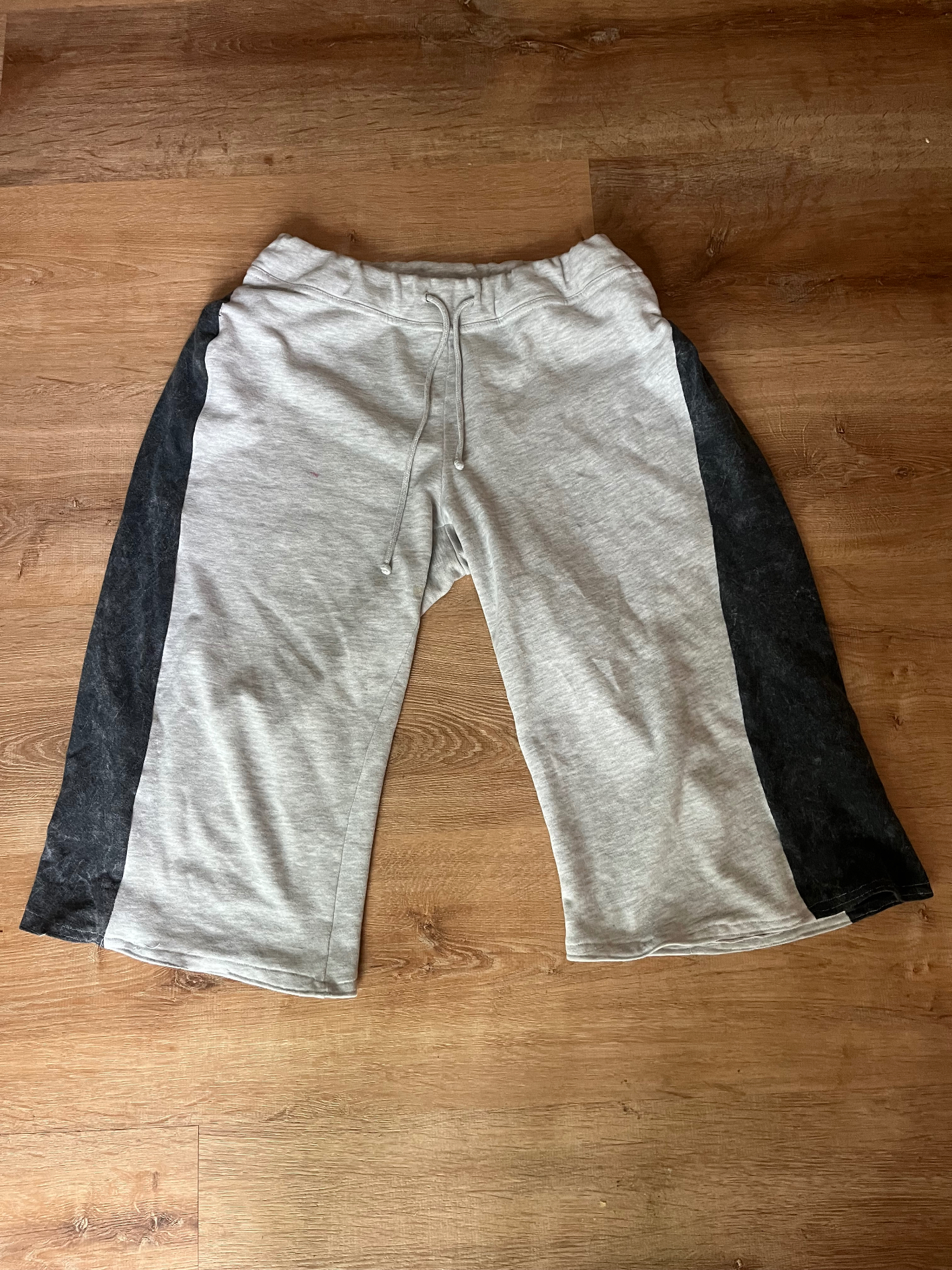 Grey sweatpants reworked into men's sweat shorts with contrast side panels